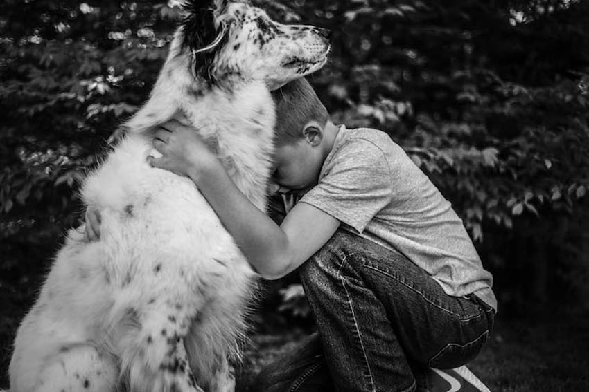 Niño abrazando a su perro