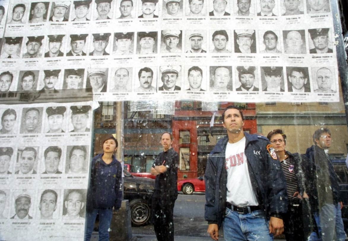 Personas examinando las fotografías de policías y bomberos desaparecidos tras los ataques al World Trade Center del 11 de septiembre de 2001. Fotografía: Mario Tama. Getty Images.